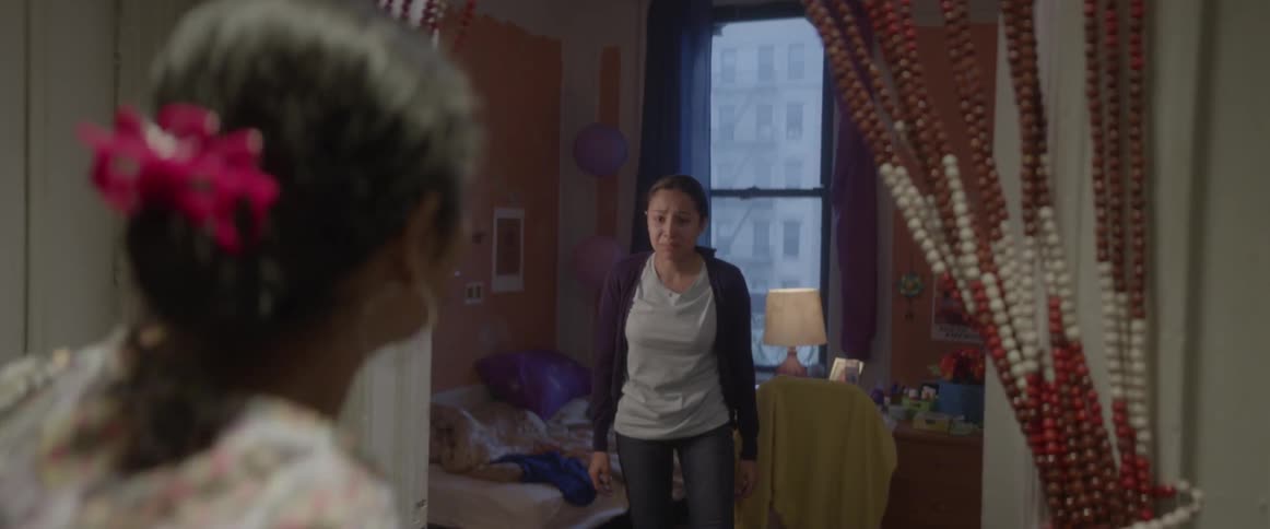 A woman stands and cries in a doorway while another woman is pulled away