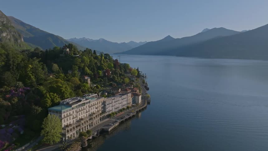 Aerial view of buildings at the foot of a mountain by the sea and on a blue sky day