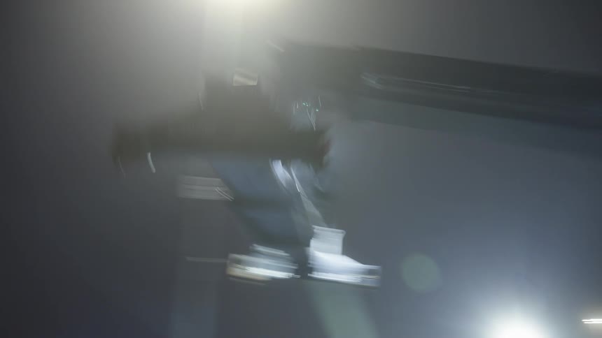 Person piloting a machine in a harbor at night
