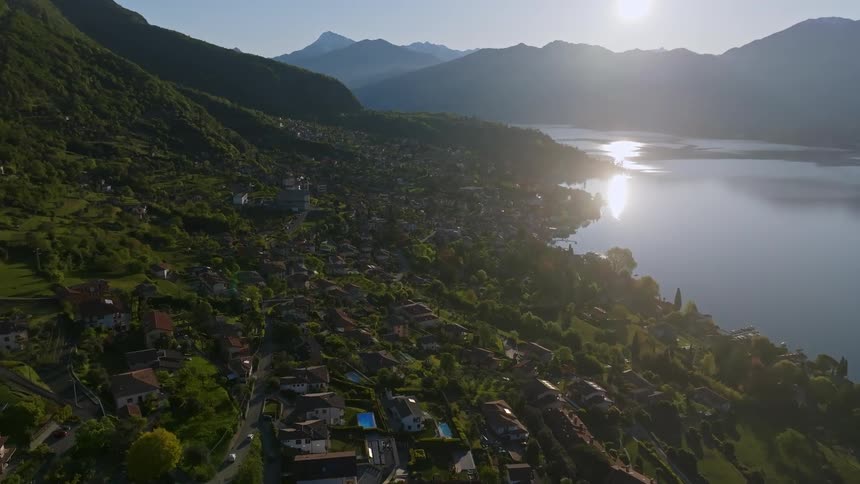 Aerial of a lakeside housing village at sunrise on a summer day