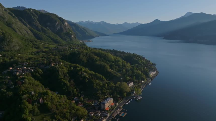 Aerial view of an urban city built at the foot of mountains on the edge of a lake