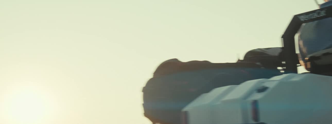 Close up of a man driving a motorized vehicle on a golf course