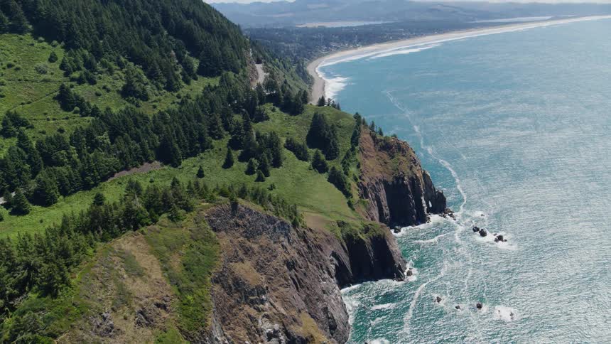 Aerial view of a coastal mountain covered in vegetation