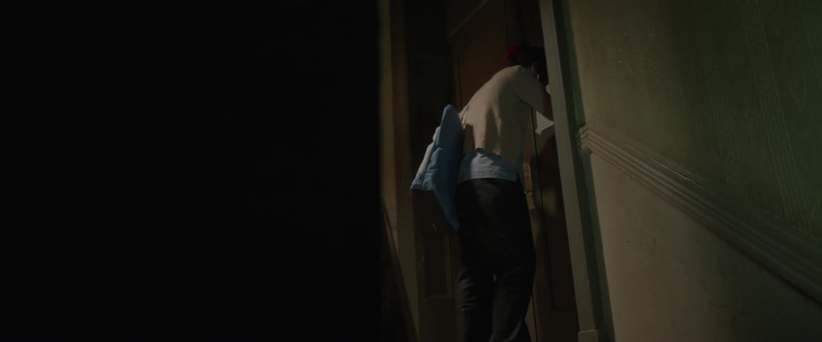 A woman bangs her head against a door
