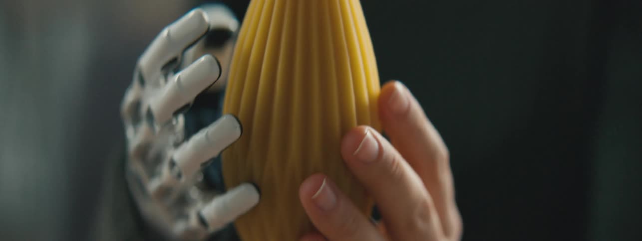 A person with a prosthetic hand is holding an object