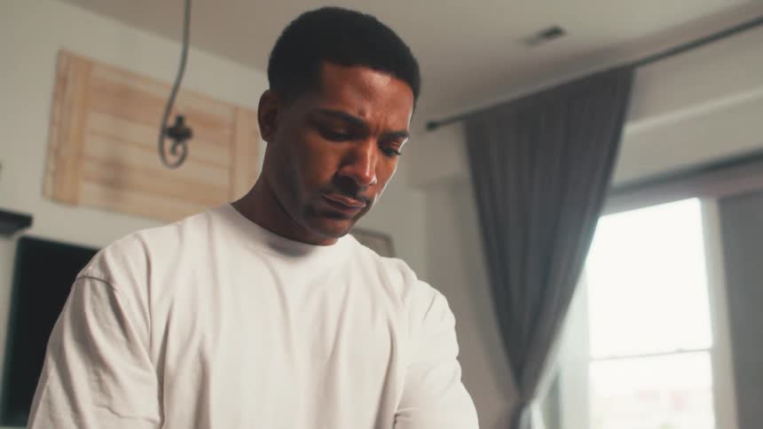 Steam rises into the face of a black man inside of a house