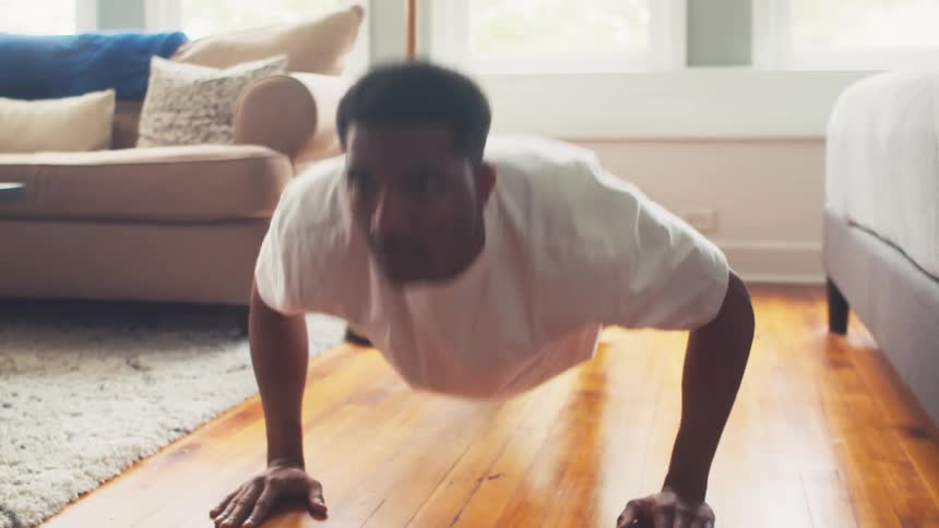 Man in living room doing pushups