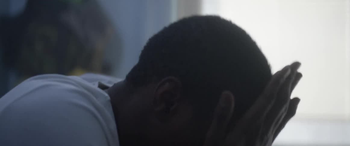 A boy gets out of bed seemingly in pain