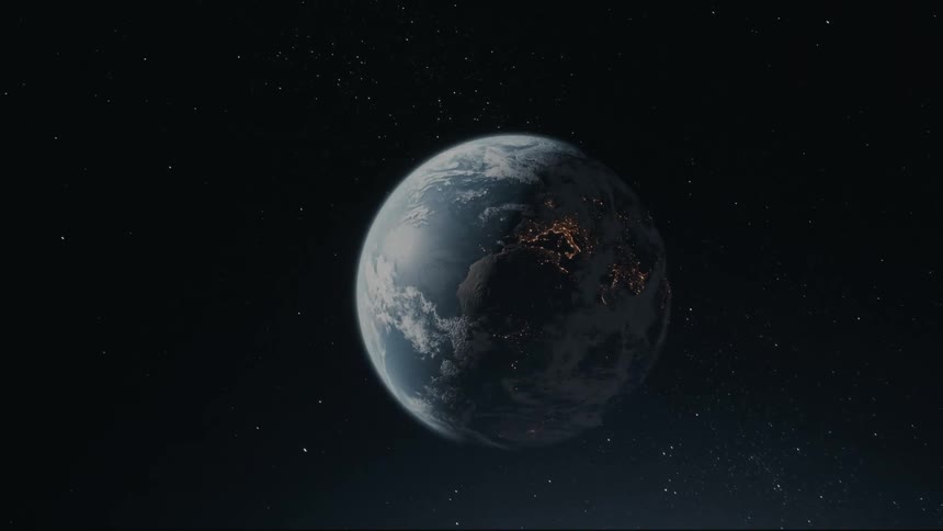 City lights dot the land on the earth rotating through space