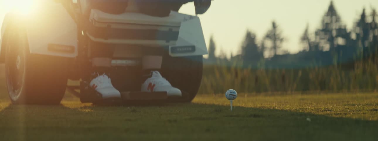 Personal vehicle lowers disabled individual to allow them to swing at golf ball
