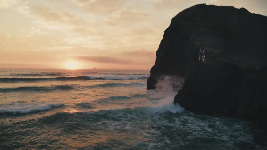 Waves crash against the rocks on the shore