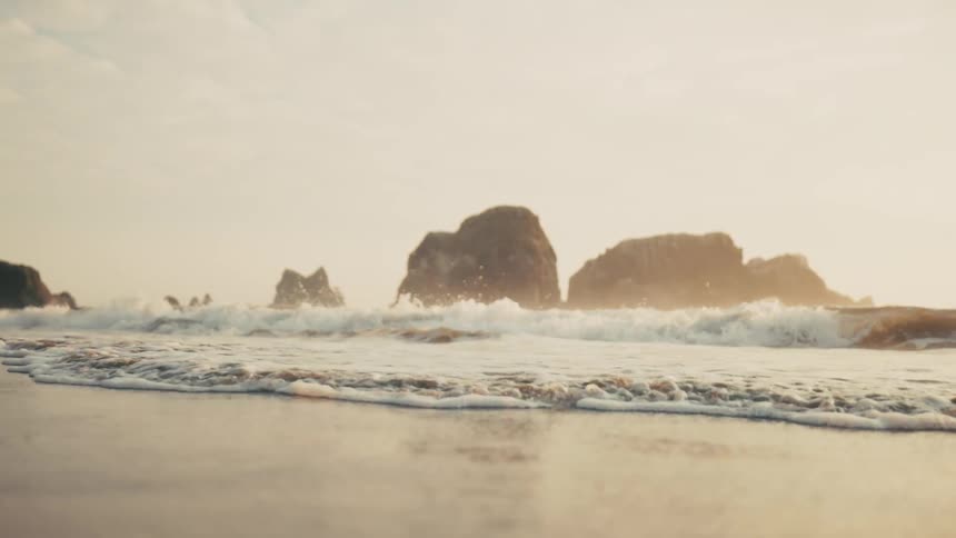 Waves waves with foam reach the beach sand