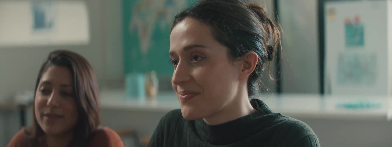 Two women sitting at a table talking to each other