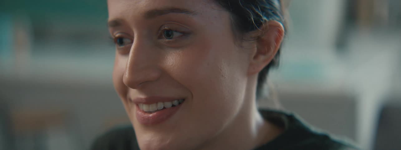 Woman smiles and nods during a conversation