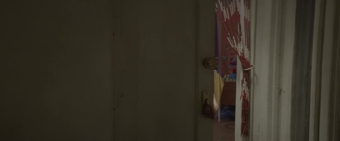A woman answers the door and is arrested by an ice officer