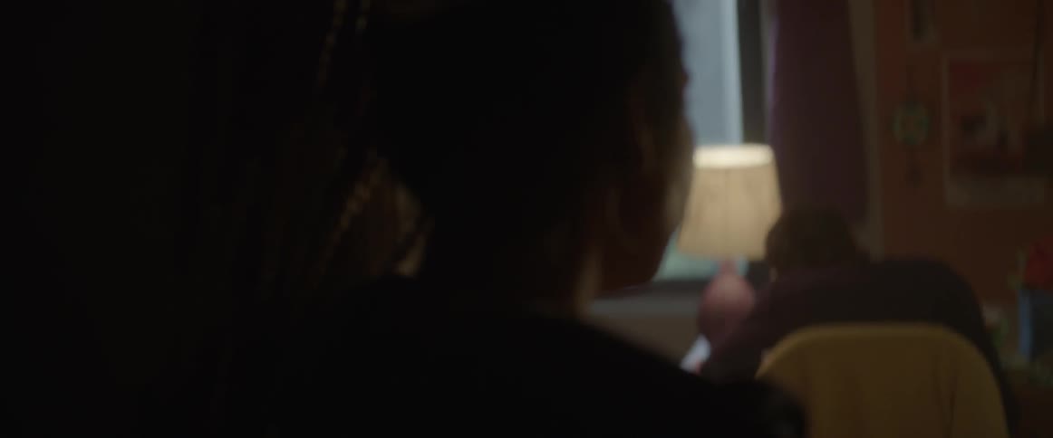 A woman looks into a bedroom