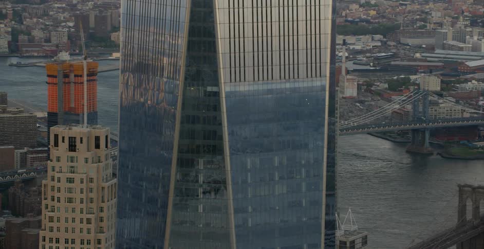 A glass skyscraper reflects the sunlight