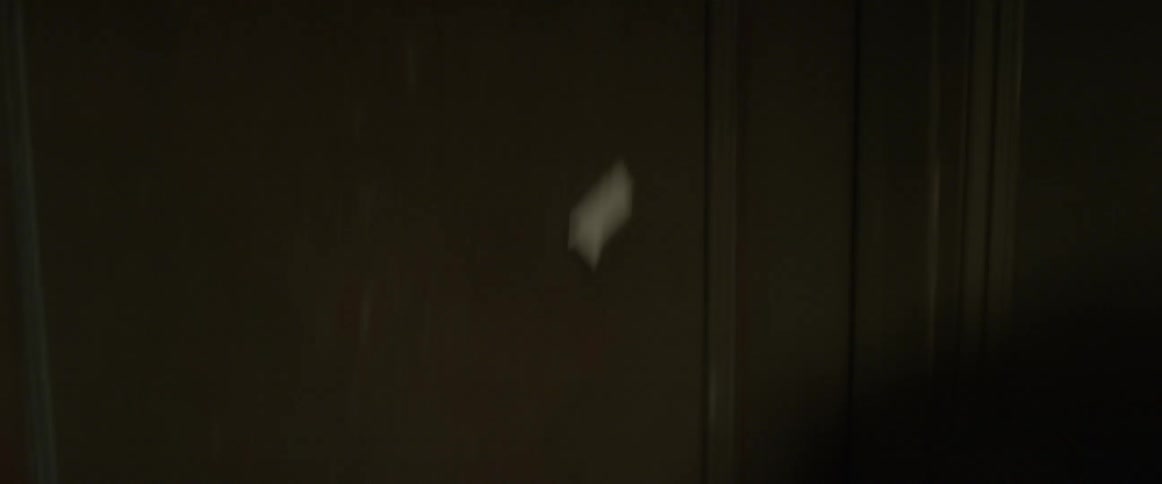 Someone ripping an eviction notice off of a doorway