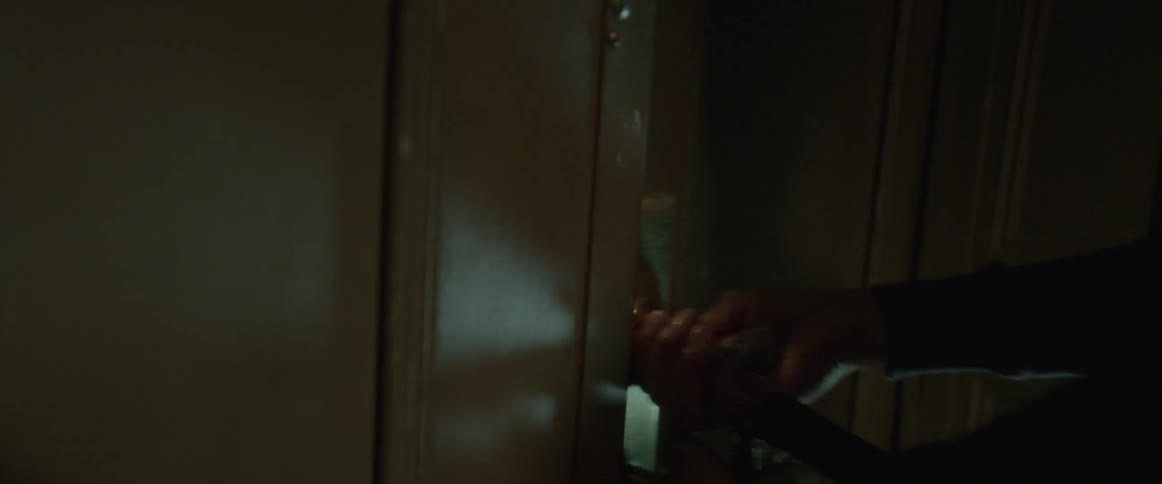 A person turns a key and unlocks a door