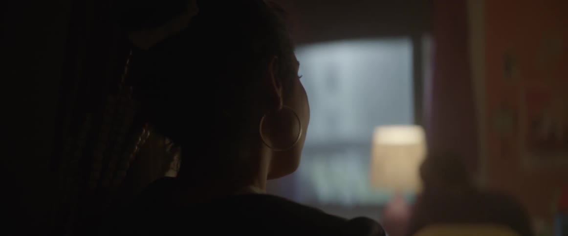 A woman is staring at someone in a bedroom