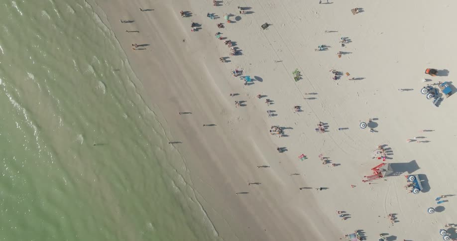 Aerial view of a beach with lots of people during a summer day