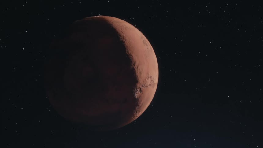 The reddish brown surface of mars appearing as a crescent against a black sky speckled with distant stars