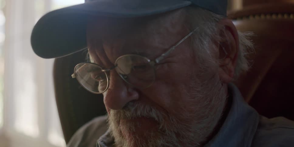 Portrait of an elderly man sitting and laughing
