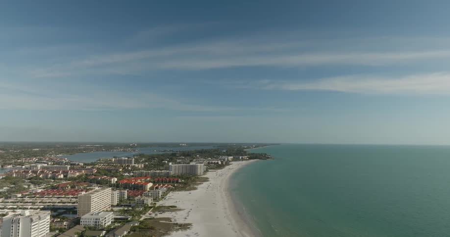 Aerial panorama of a seaside metropolis with a long stretch of sand