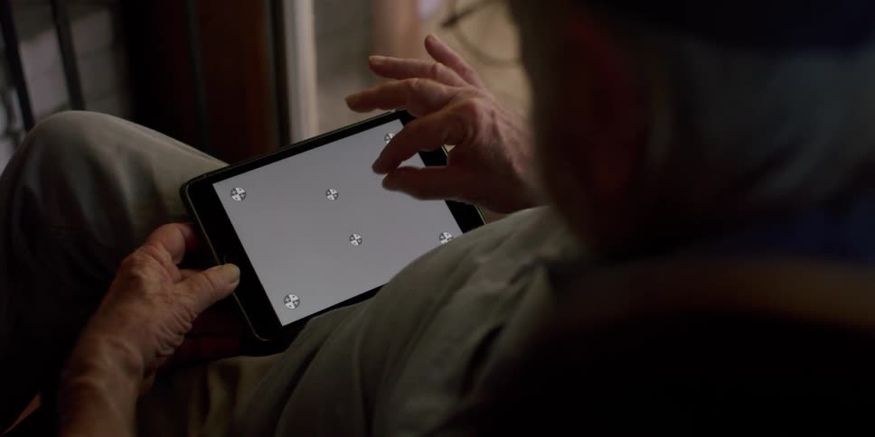 A man is touching the screen on the tablet