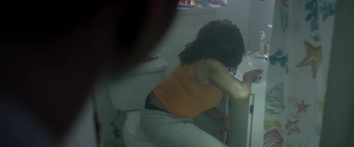 A man catches a woman smoking a cigarette in the bathroom