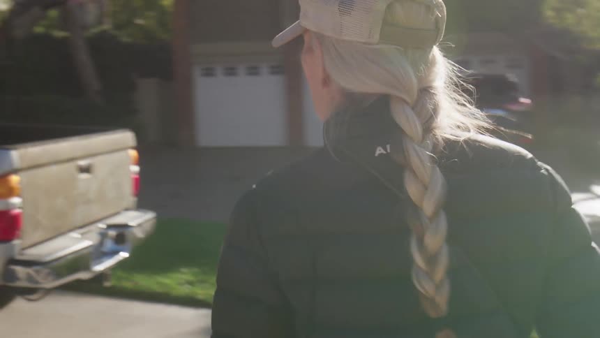 Woman walking along a trail until she reaches her truck to drop off her bag and get into the vehicle