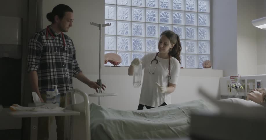 Nurse opens an iv bag showing a man