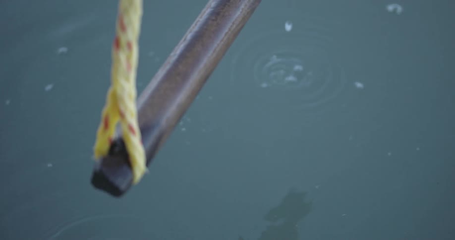 Water drips off a wood handle