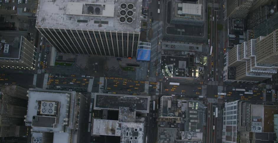 Cars drive through a busy city area