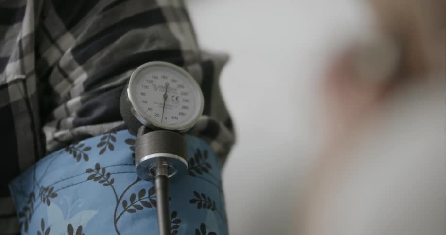 Someone is getting their blood pressure checked at a doctors