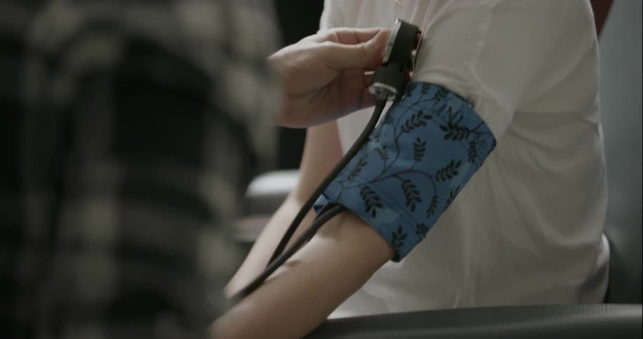 Person getting their blood pressure checked from another