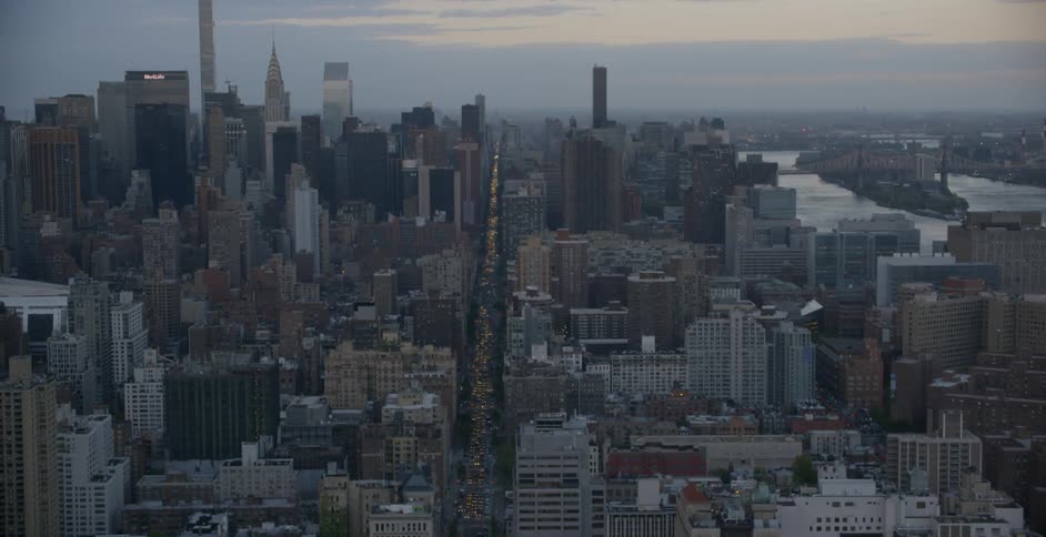 There is heavy traffic in the large city below at sunset