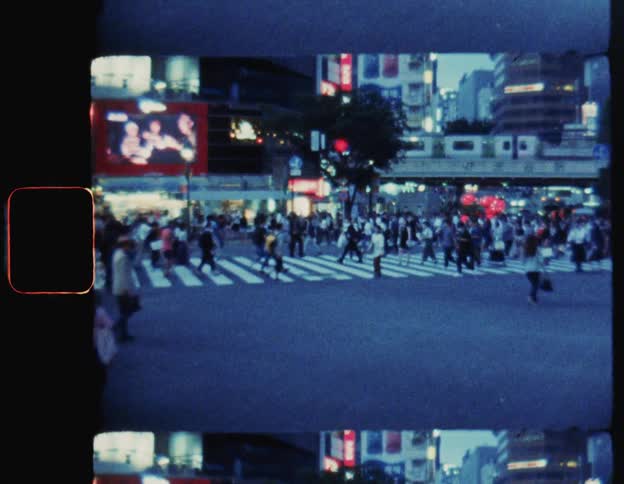 Crowd of pedestrians crossing the street in a metropolis Tokyo in the late afternoon
