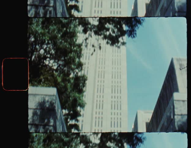 Three people walking up the stairs through the city in a metropolis with large buildings