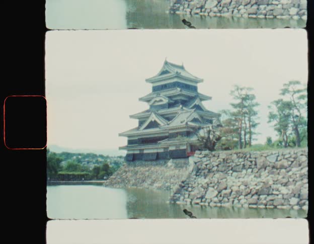 Asian architecture temple by a lake on a cloudy day