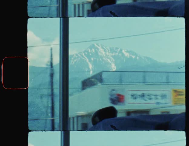 Bus in motion and with a view of a snowy mountain on the horizon Mount Fuji