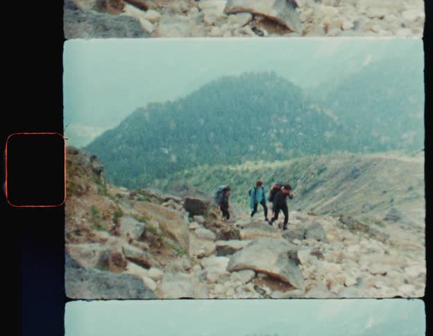 Three people are hiking up the mountain