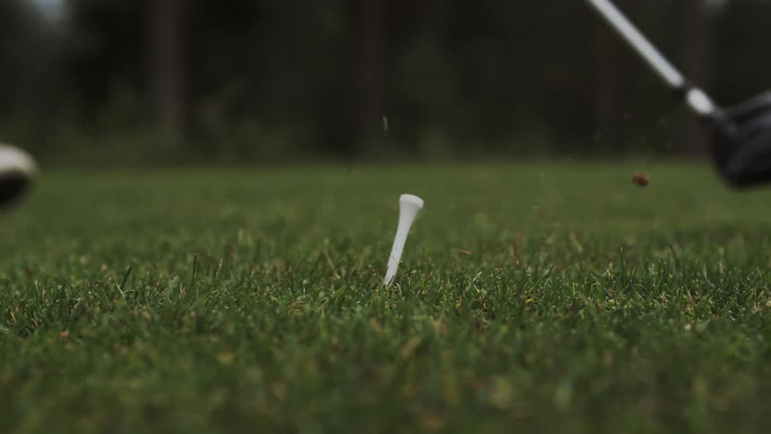 A golf club hitting a ball