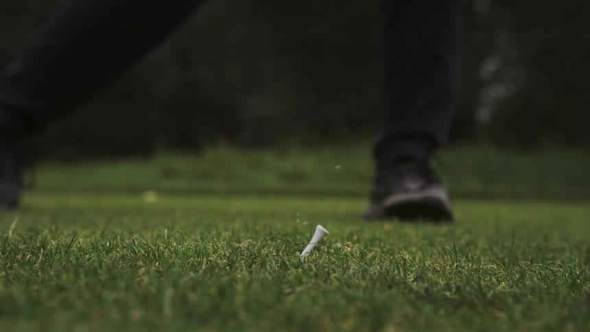 A golf club hitting a ball