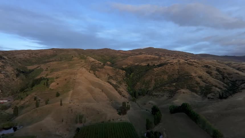 Aerial panorama of rolling hills in pre-dawn light