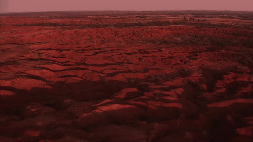 The sun is rising on the desert