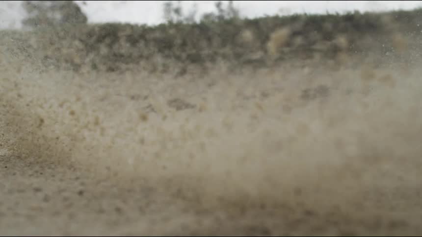 A golf ball is hit out of the sand trap