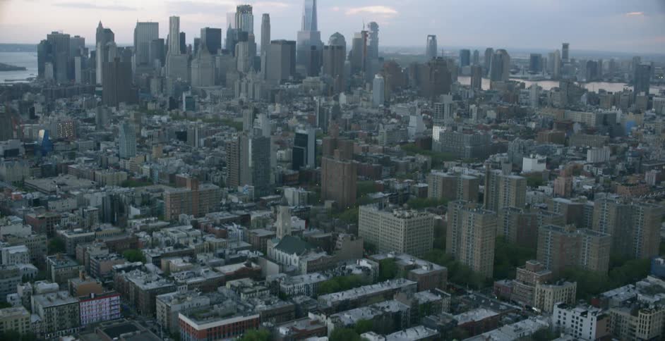A large city stretches out to the horizon at dusk