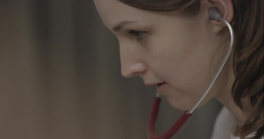 A nurse uses a stethoscope
