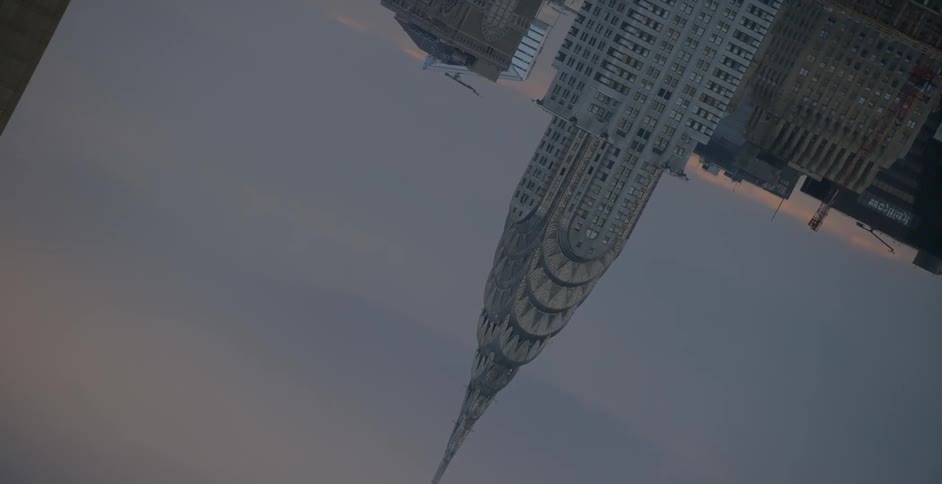 An upside view of the tops of buildings and it looks like it is spinning